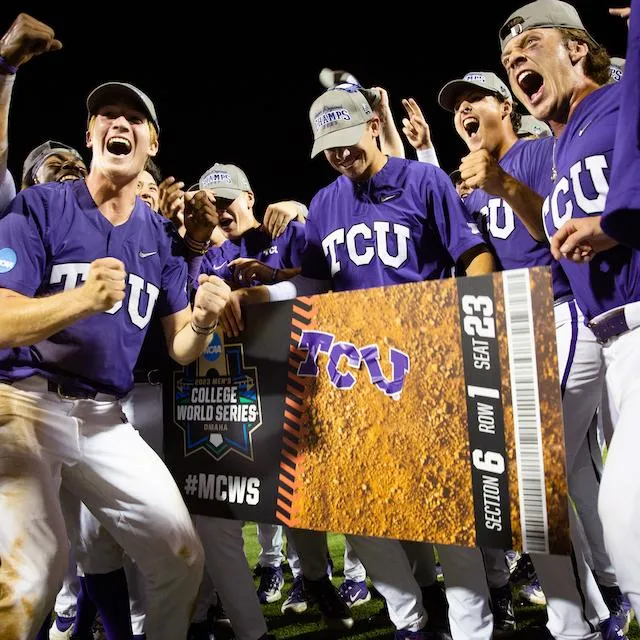 TCU baseball players in purple uniforms celebrating with College World Series Omaha ticket sign
