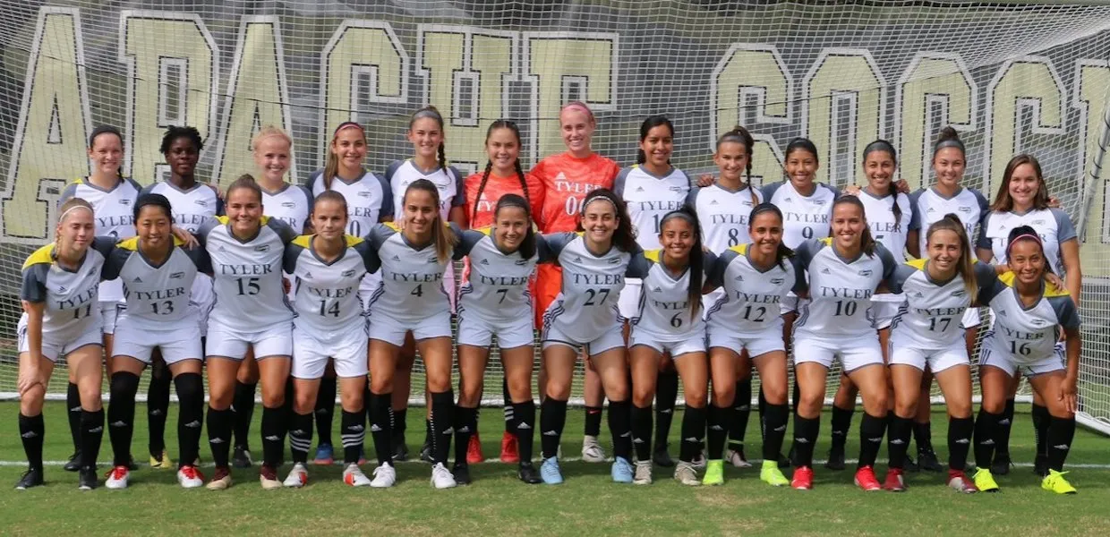 Full team portrait of 22 Tyler Junior College women's players wearing white jerseys and black socks